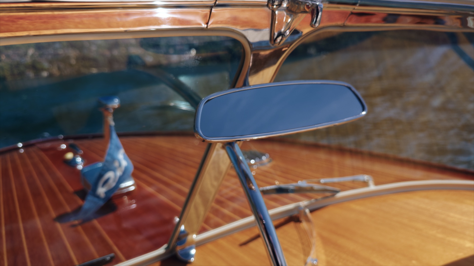 Mirror and chrome details inside a varnished wooden Riva boat on Lake Como